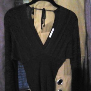 Violet bloom sweater, hugs midsection and sleeves flare slightly at the wrists